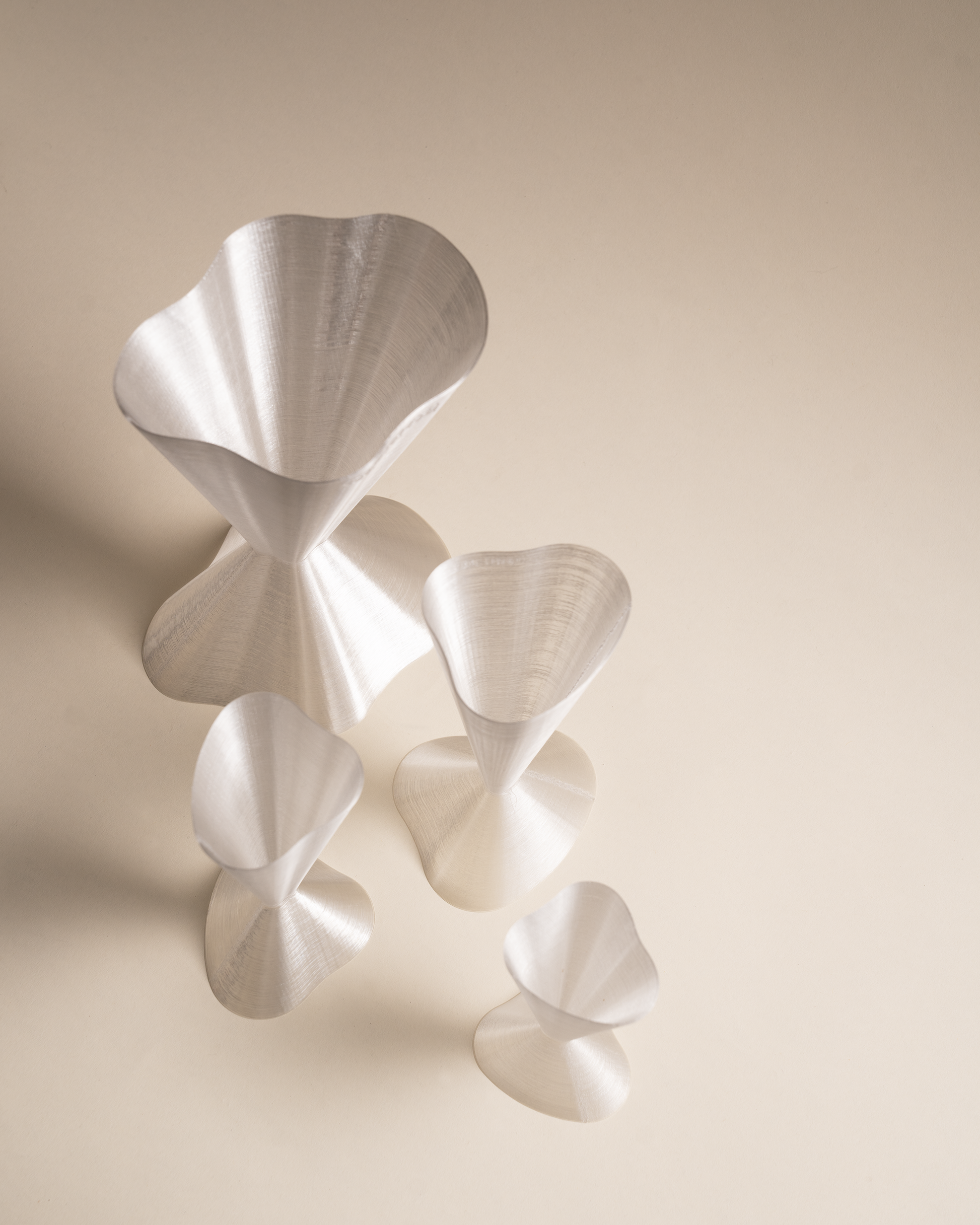 Collection of Buka Glasses in three sizes and a Goblet, 3D-printed from eco-friendly and bio-based PLA filament. Sleek, organic designs that combine sustainability, innovation, and modern style.