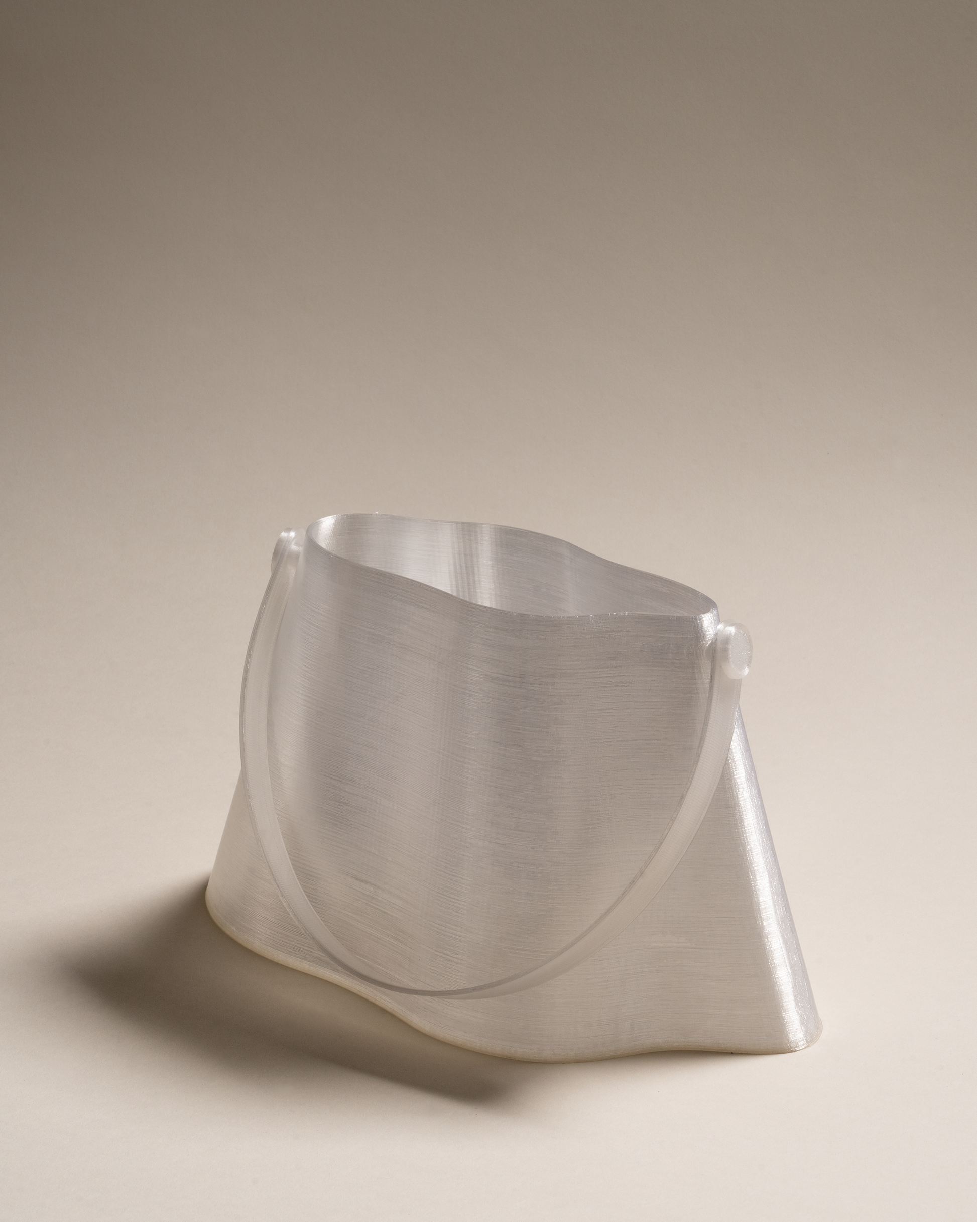 Shell Midi Bag in Ice, fully 3D-printed from recycled transparent TPU. Unique, edgy design with layered texture, combining sustainability and eco-conscious craftsmanship.