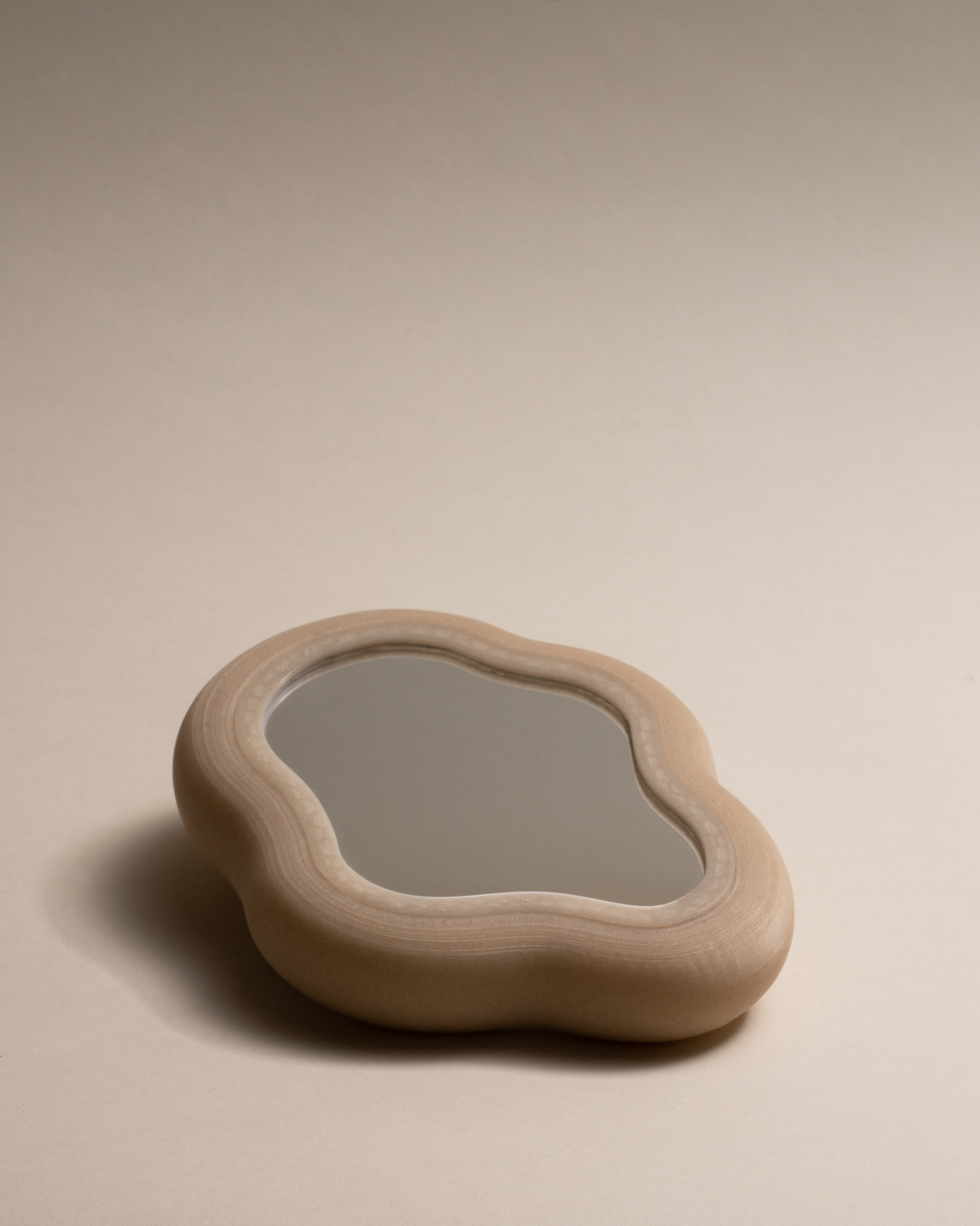 Blob Mirror, 3D-printed from eco-friendly PLA filaments mixed with natural by-products like oyster, mussel, scallop shells and wheat offcuts. Unique organic shape, versatile as a hand mirror or chic tray, with sustainable, non-toxic craftsmanship.