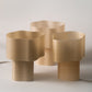 Collection of Cloudy Lamps in various earthy colors, 3D-printed from PLA filaments mixed with natural by-products like mussel shells, oysters, scallops, and wheat offcuts. Eco-friendly, with unique textures and colors created through recycling waste from agriculture and catering. Provides ambient, decorative light.
