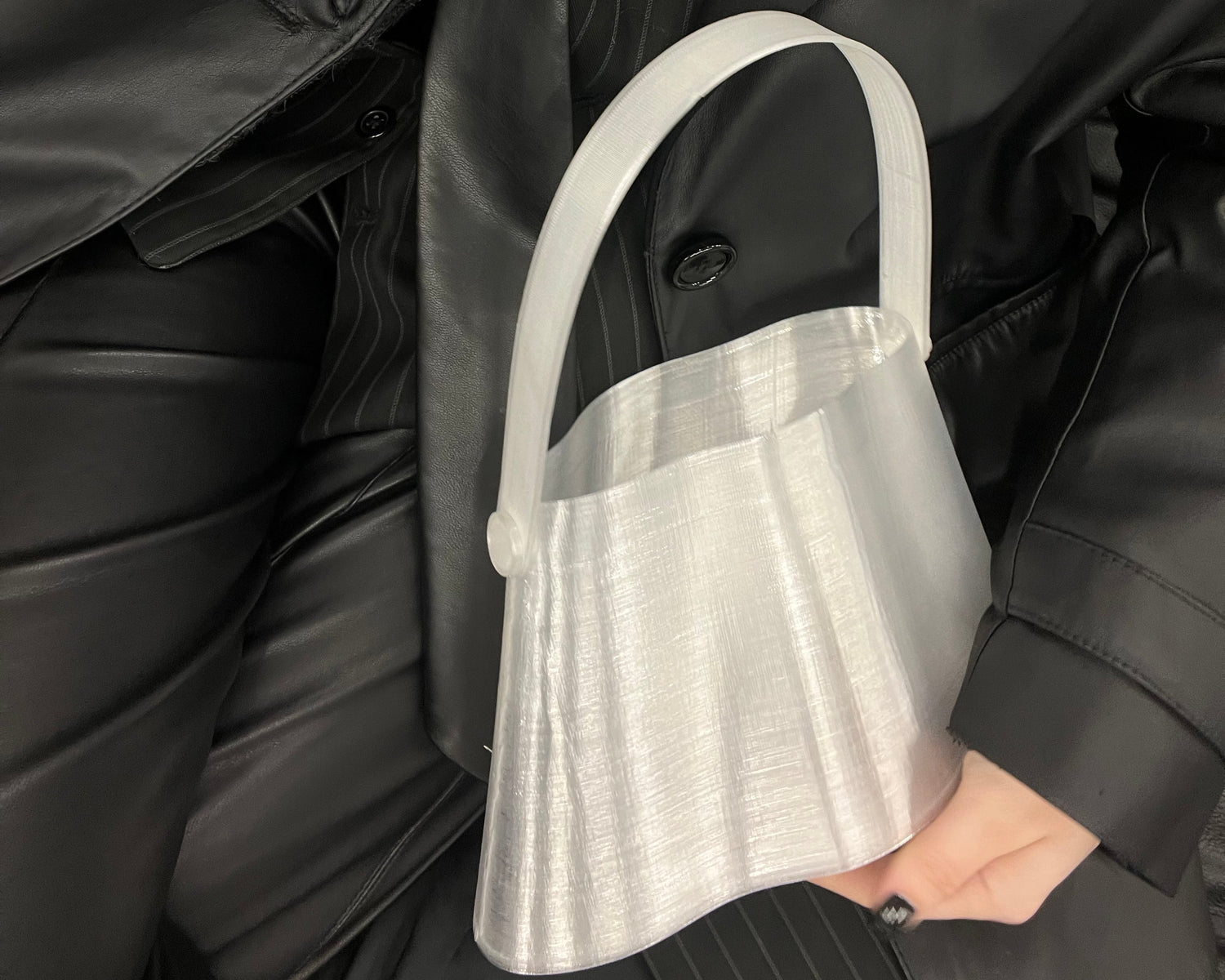 Shell Midi Bag in Ice, fully 3D-printed from recycled transparent TPU. Unique, edgy design with layered texture, combining sustainability and eco-conscious craftsmanship.