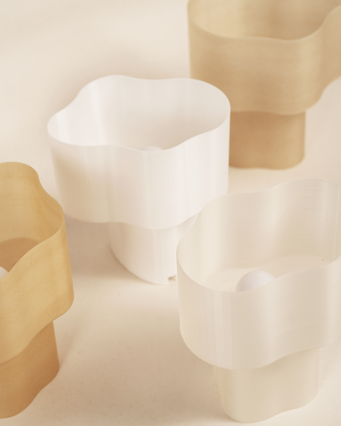 Collection of Cloudy Lamps in various earthy colors, 3D-printed from PLA filaments mixed with natural by-products like mussel shells, oysters, scallops, and wheat offcuts. Eco-friendly, with unique textures and colors created through recycling waste from agriculture and catering. Provides ambient, decorative light.